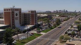 5.7K aerial stock footage pan from street and skyline to hospital complex in Phoenix, Arizona Aerial Stock Footage | DX0002_140_022