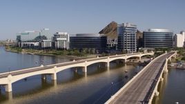 5.7K aerial stock footage fly away from and past bridges leading to waterfront office buildings in Tempe, Arizona Aerial Stock Footage | DX0002_142_008