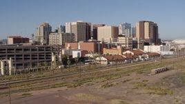 5.7K aerial stock footage of the city's skyline seen from a parking garage and train station in Downtown Phoenix, Arizona Aerial Stock Footage | DX0002_142_015