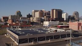 5.7K aerial stock footage of the city's skyline seen while flying past train station in Downtown Phoenix, Arizona Aerial Stock Footage | DX0002_142_023