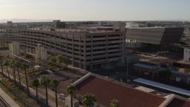 5.7K aerial stock footage fly away from and orbit parking garage by the sheriff's office at sunset in Downtown Phoenix, Arizona Aerial Stock Footage | DX0002_142_036