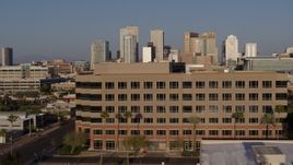 5.7K aerial stock footage the city's skyline while flying by state government offices at sunset in Downtown Phoenix, Arizona Aerial Stock Footage | DX0002_143_003
