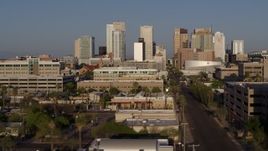 5.7K aerial stock footage flying near Adams Street to approach city's skyline at sunset in Downtown Phoenix, Arizona Aerial Stock Footage | DX0002_143_009