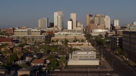 5.7K aerial stock footage follow Adams Street toward city's skyline at sunset in Downtown Phoenix, Arizona Aerial Stock Footage | DX0002_143_012