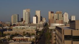 5.7K aerial stock footage focus on city's skyline at sunset, flyby rooftop to reveal Adams Street, Downtown Phoenix, Arizona Aerial Stock Footage | DX0002_143_017