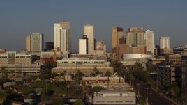 5.7K aerial stock footage the city's skyline at sunset seen from Adams Street, Downtown Phoenix, Arizona Aerial Stock Footage | DX0002_143_022