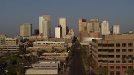 5.7K aerial stock footage the city's skyline at sunset while passing Adams Street, Downtown Phoenix, Arizona Aerial Stock Footage | DX0002_143_024
