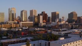 5.7K aerial stock footage of a reverse view of the city's skyline at sunset, Downtown Phoenix, Arizona Aerial Stock Footage | DX0002_143_034