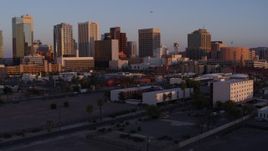 5.7K aerial stock footage of flying by tall office towers in the city's skyline at sunset, Downtown Phoenix, Arizona Aerial Stock Footage | DX0002_143_042