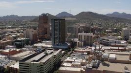 5.7K aerial stock footage of ascending past office high-rises, with Sentinel Peak in the distance, Downtown Tucson, Arizona Aerial Stock Footage | DX0002_144_002