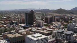 5.7K aerial stock footage ascend past courthouse to orbit office high-rises and reveal Sentinel Peak, Downtown Tucson, Arizona Aerial Stock Footage | DX0002_144_009
