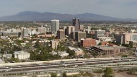 5.7K aerial stock footage reverse view of tall office high-rises and city buildings, seen from I-10, Downtown Tucson, Arizona Aerial Stock Footage | DX0002_144_039