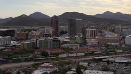 5.7K aerial stock footage approach office towers as a train passes, with Sentinel Peak in the background, Downtown Tucson, Arizona Aerial Stock Footage | DX0002_145_037