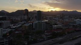 5.7K aerial stock footage of passing office towers at sunset in Downtown Tucson, Arizona Aerial Stock Footage | DX0002_146_028