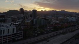 5.7K aerial stock footage flying by tall office towers and city buildings at sunset in Downtown Tucson, Arizona Aerial Stock Footage | DX0002_146_032