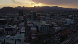 5.7K aerial stock footage a view of tall office towers and city buildings with view of setting sun in Downtown Tucson, Arizona Aerial Stock Footage | DX0002_146_034