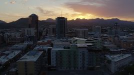 5.7K aerial stock footage orbit and fly away from high-rise office towers and setting sun in Downtown Tucson, Arizona Aerial Stock Footage | DX0002_146_040