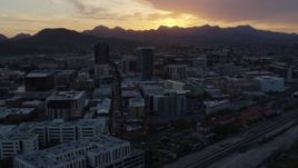 5.7K aerial stock footage fly away from and past high-rise office towers with view of Sentinel Peak at sunset in Downtown Tucson, Arizona Aerial Stock Footage | DX0002_146_041