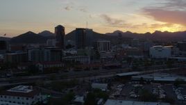5.7K aerial stock footage flyby railroad tracks while focused on high-rise office towers at sunset in Downtown Tucson, Arizona Aerial Stock Footage | DX0002_146_043