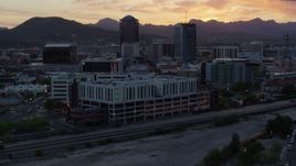 5.7K aerial stock footage focusing on high-rise office towers at sunset while flying away from Downtown Tucson, Arizona Aerial Stock Footage | DX0002_147_003