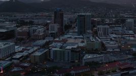 5.7K aerial stock footage flying by high-rise office towers at sunset with Sentinel Peak in distance, Downtown Tucson, Arizona Aerial Stock Footage | DX0002_147_005