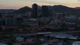 5.7K aerial stock footage passing high-rise office towers at sunset with Sentinel Peak in distance, Downtown Tucson, Arizona Aerial Stock Footage | DX0002_147_006