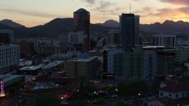 5.7K aerial stock footage approach and orbit high-rise office towers at sunset with mountains in distance, Downtown Tucson, Arizona Aerial Stock Footage | DX0002_147_009