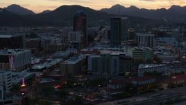 5.7K aerial stock footage passing office towers at sunset with mountains in distance, Downtown Tucson, Arizona Aerial Stock Footage | DX0002_147_012