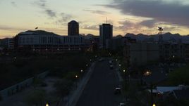 5.7K aerial stock footage ascend toward office towers at sunset, seen from apartment buildings, Downtown Tucson, Arizona Aerial Stock Footage | DX0002_147_016