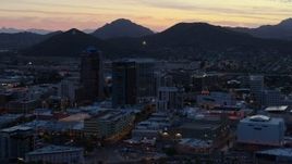 5.7K aerial stock footage tall office towers at sunset, Sentinel Peak in the distance, Downtown Tucson, Arizona Aerial Stock Footage | DX0002_147_018