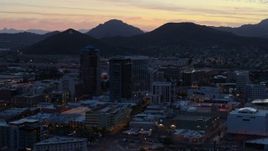 5.7K aerial stock footage of passing tall office towers at sunset, Sentinel Peak in the distance, Downtown Tucson, Arizona Aerial Stock Footage | DX0002_147_019