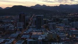 5.7K aerial stock footage focus on tall office towers at sunset while flying by Downtown Tucson, Arizona Aerial Stock Footage | DX0002_147_020