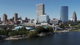5.7K aerial stock footage of tall skyscrapers seen while flying by a waterfront outdoor stage in Downtown Milwaukee, Wisconsin Aerial Stock Footage | DX0002_149_031