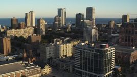 5.7K aerial stock footage of flying by the skyline seen from college campus at sunset in Downtown Milwaukee, Wisconsin Aerial Stock Footage | DX0002_150_018