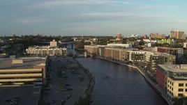 5.7K aerial stock footage ascend past apartment complexes by the Milwaukee River at sunset, Milwaukee, Wisconsin Aerial Stock Footage | DX0002_150_024