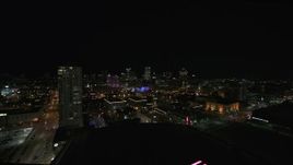 5.7K aerial stock footage pan from a high-rise apartment building at night, focus on skyline, Downtown Milwaukee, Wisconsin Aerial Stock Footage | DX0002_151_013