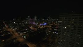 5.7K aerial stock footage fly around apartment high-rise toward city skyline at night, Downtown Milwaukee, Wisconsin Aerial Stock Footage | DX0002_151_016