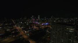 5.7K aerial stock footage fly away from skyline to reveal an apartment high-rise at night, Downtown Milwaukee, Wisconsin Aerial Stock Footage | DX0002_151_018