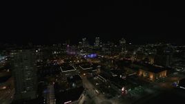 5.7K aerial stock footage reverse view of the city skyline and apartment high-rise at night, Downtown Milwaukee, Wisconsin Aerial Stock Footage | DX0002_151_020