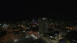 5.7K aerial stock footage passing an apartment high-rise at night, Downtown Milwaukee, Wisconsin Aerial Stock Footage | DX0002_151_021