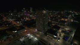 5.7K aerial stock footage flying away from an apartment high-rise at night, Downtown Milwaukee, Wisconsin Aerial Stock Footage | DX0002_151_024