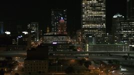 5.7K aerial stock footage of flying by the Wisconsin Gas Building in Downtown Milwaukee, Wisconsin at night Aerial Stock Footage | DX0002_151_041