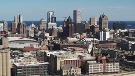 5.7K aerial stock footage of the city's skyline in Downtown Milwaukee, Wisconsin, descend near industrial buildings Aerial Stock Footage | DX0002_152_016
