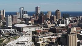 5.7K aerial stock footage of the city's skyline in Downtown Milwaukee, Wisconsin, ascend near industrial buildings Aerial Stock Footage | DX0002_152_017