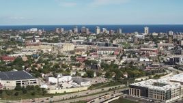 5.7K aerial stock footage of lakeside apartment buildings seen across the city in Milwaukee, Wisconsin Aerial Stock Footage | DX0002_152_025
