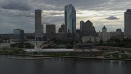 5.7K aerial stock footage reverse view of city's waterfront museum and skyline from Lake Michigan in Downtown Milwaukee, Wisconsin Aerial Stock Footage | DX0002_154_016