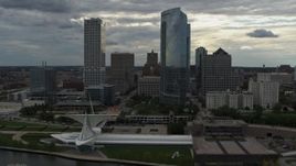 5.7K aerial stock footage ascend toward city's waterfront museum and skyline from the lake in Downtown Milwaukee, Wisconsin Aerial Stock Footage | DX0002_154_018