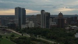 5.7K aerial stock footage flying by the tall skyscrapers the city's skyline at sunset, Downtown Milwaukee, Wisconsin Aerial Stock Footage | DX0002_155_010