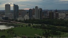 5.7K aerial stock footage of the city's skyline seen from green park at sunset, Downtown Milwaukee, Wisconsin Aerial Stock Footage | DX0002_155_012