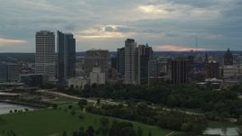 5.7K aerial stock footage of tall skyscrapers in the city's skyline seen from green park at sunset, Downtown Milwaukee, Wisconsin Aerial Stock Footage | DX0002_155_013